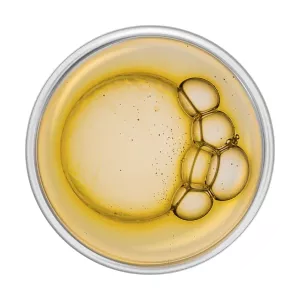 A small glass dish of vitamin E oil, an ingredient used for Nutricentials Dew All Day Moisture Restore Cream.