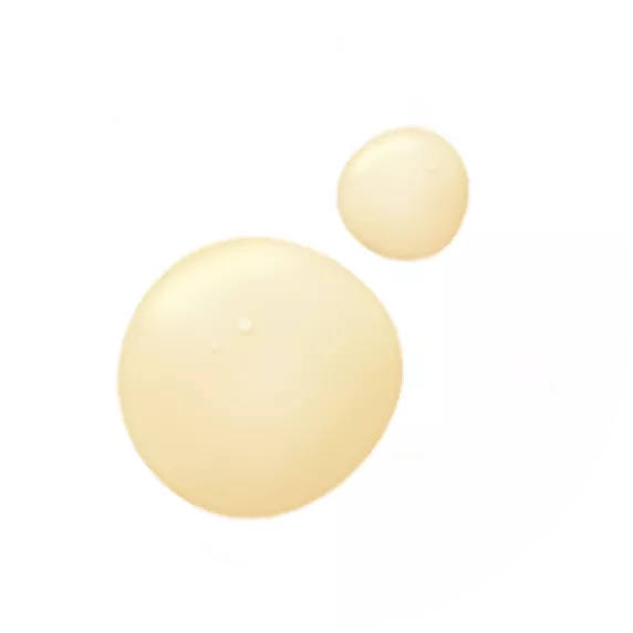 Two small puddles of pistachio nut oil, an ingredient used for Dew All Day Moisture Restore Cream.
